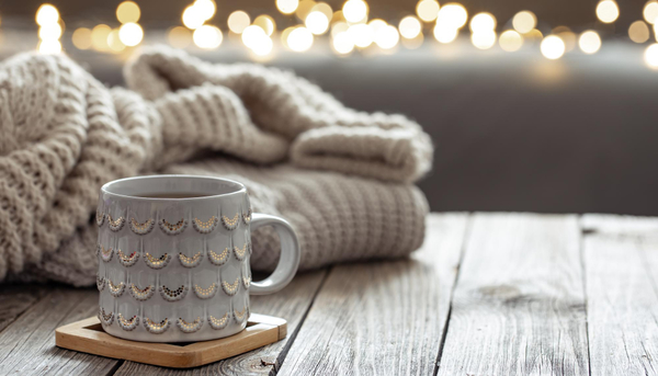 Beautiful-christmas-cup-and-knitted-element-on-blurred-background-with-bokeh