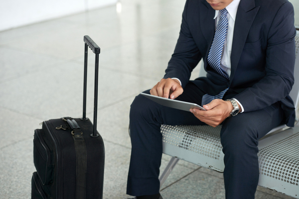 Businessman-using-tablet-computer-in-airport