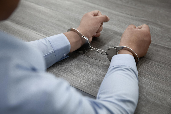 Hands-in-handcuffs-table